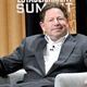Activision Blizzard CEO Bobby Kotick sits on stage at a conference.